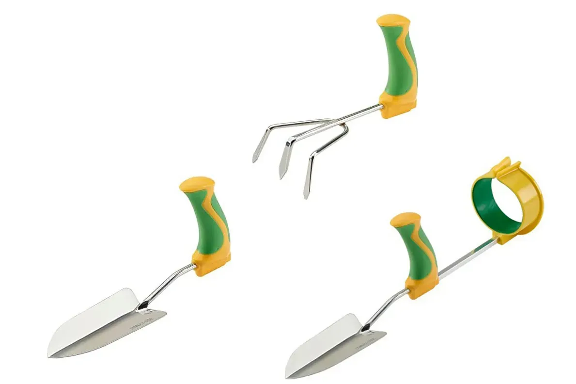 A gardener uses a long-reach cultivator to aerate soil while standing upright comfortably.