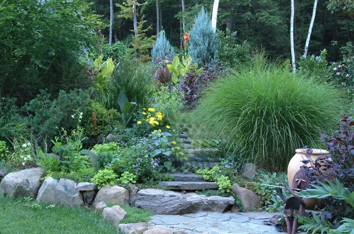 Flagstone pavers and gravel form a simple low maintenance garden layout.